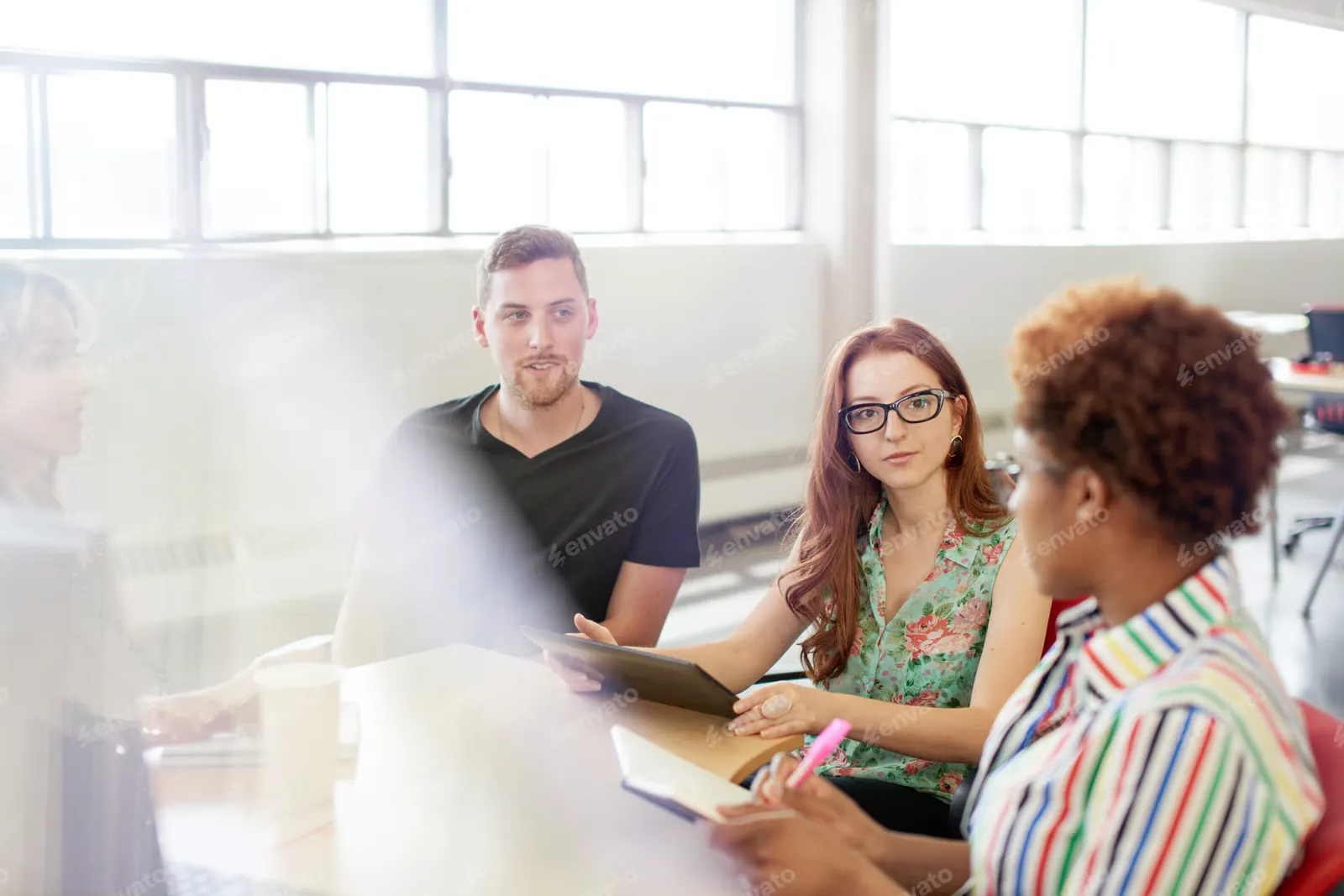A group of people having a meeting in a office
