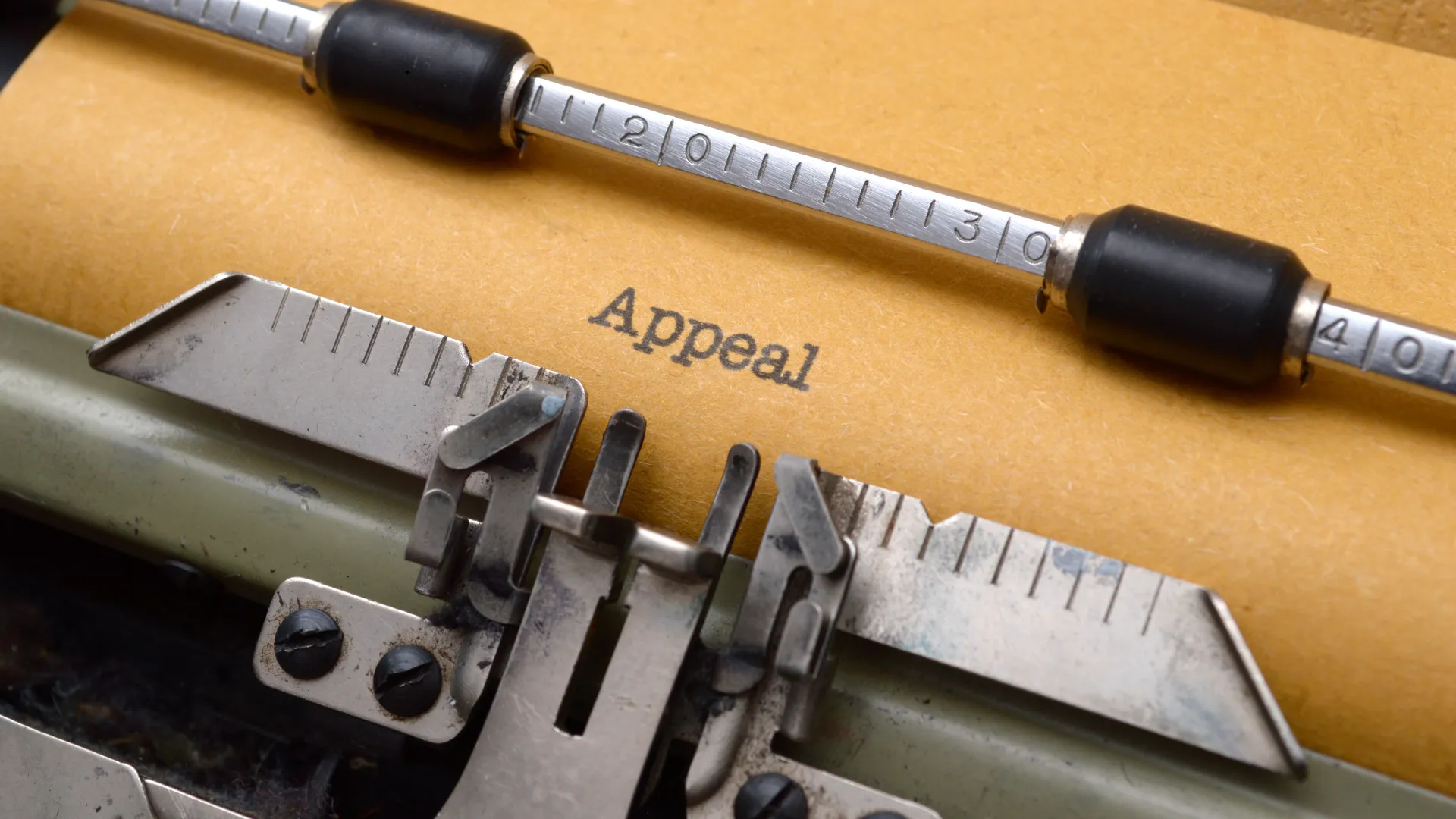 A typewriter with a piece of paper that has the word "Appeal" typed on it
