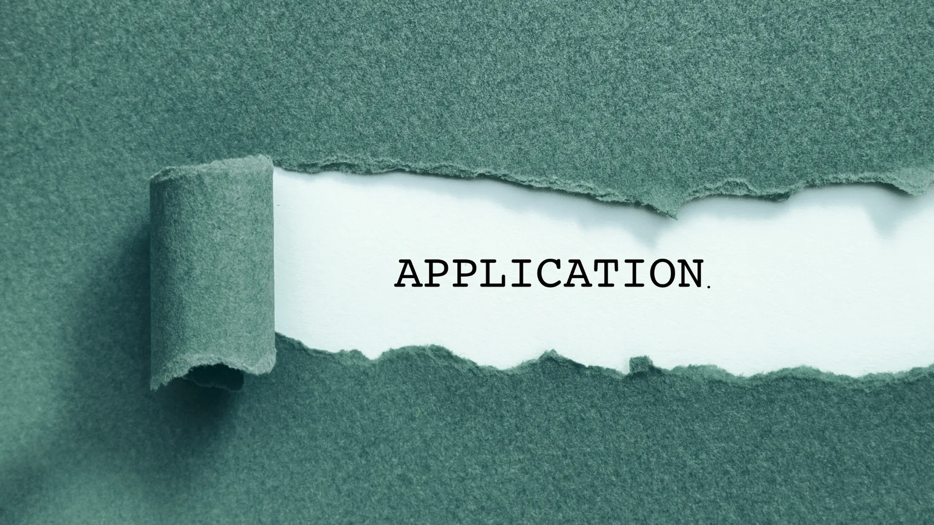 A torn piece of green paper revealing the word 'APPLICATION' in black capital letters on a white background