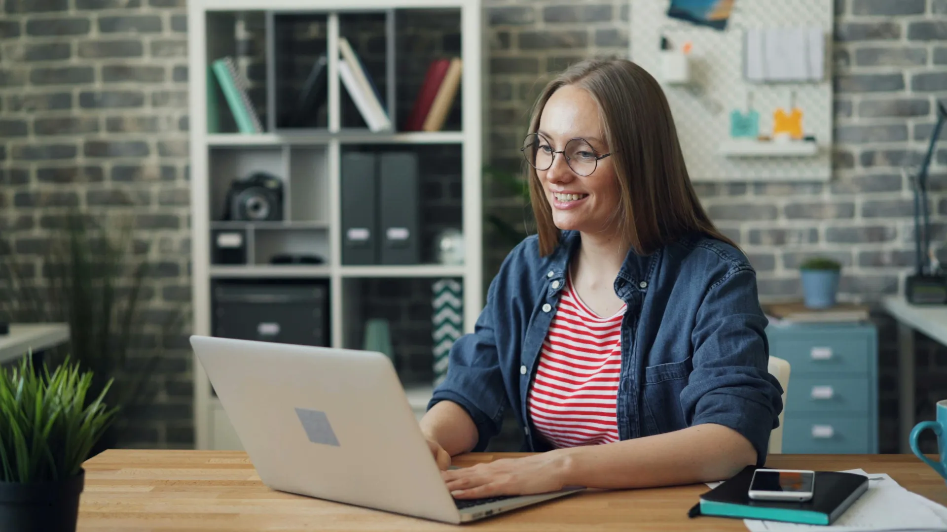 A person working on a laptop in a office