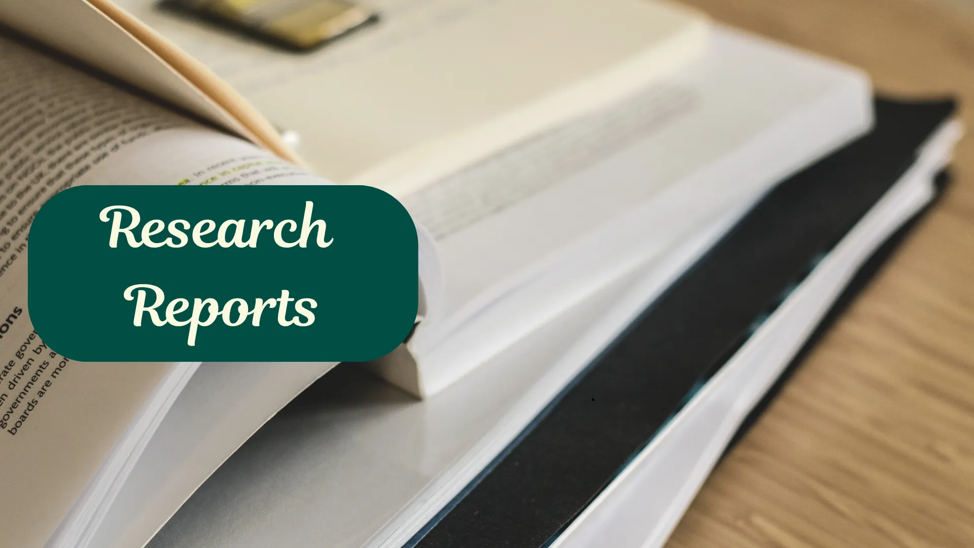 A stack of books with the text "Research Reports" overlaid on it.