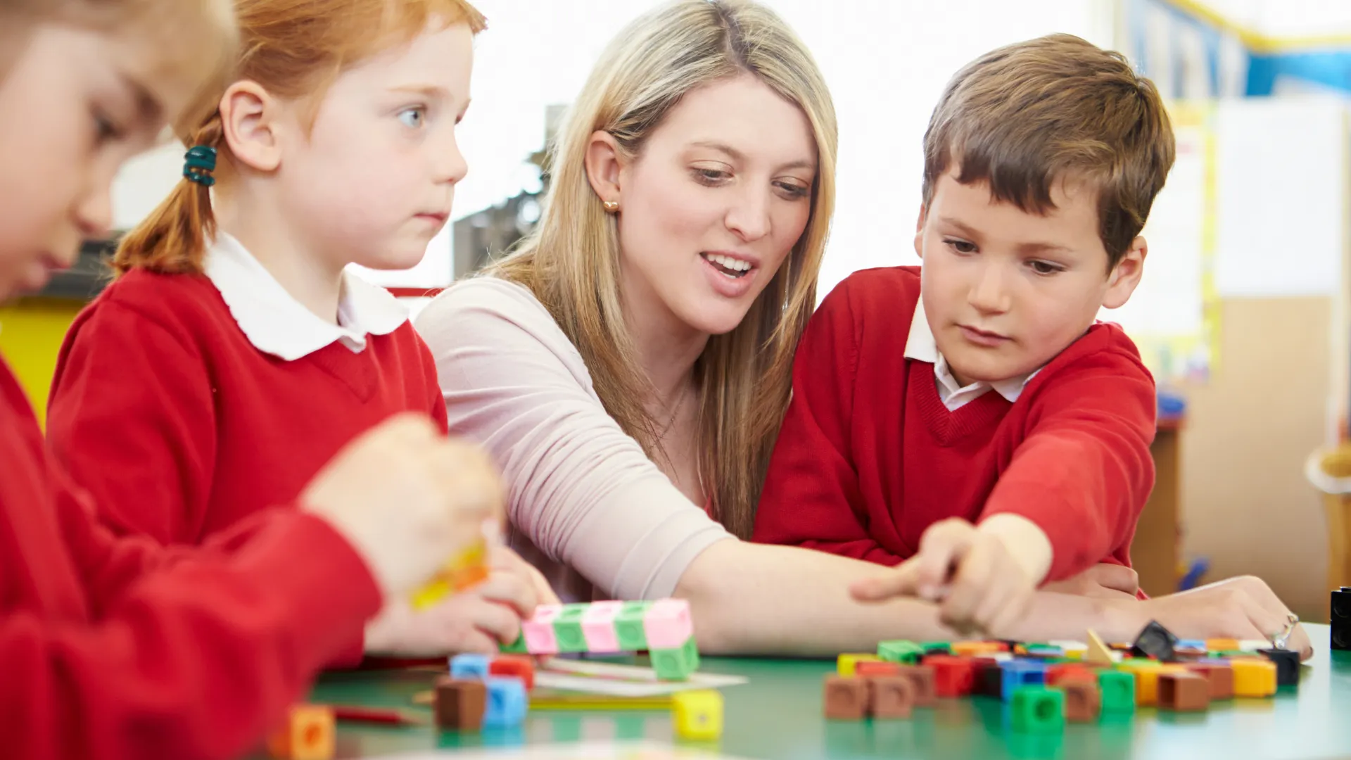 Pupils and teacher working with colourful building blocks