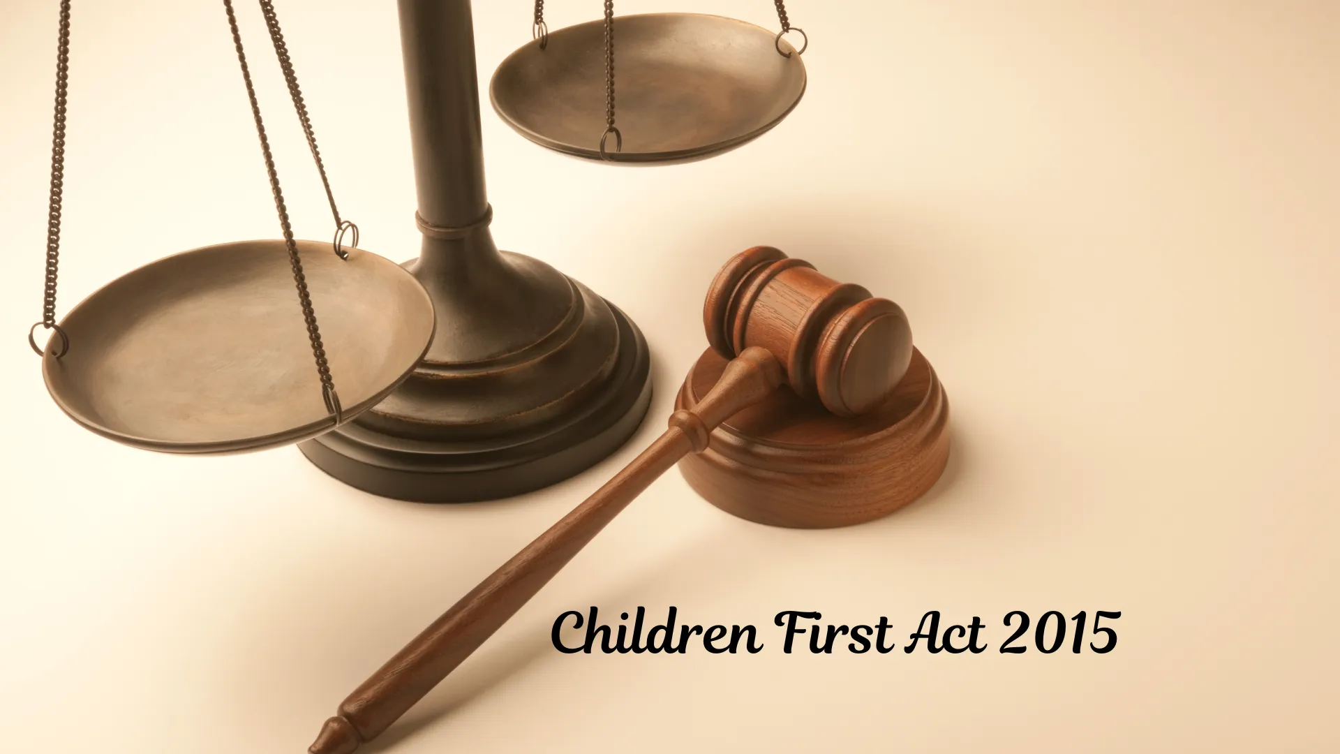 Scales of justice and a gavel with the text "Children First Act 2015".