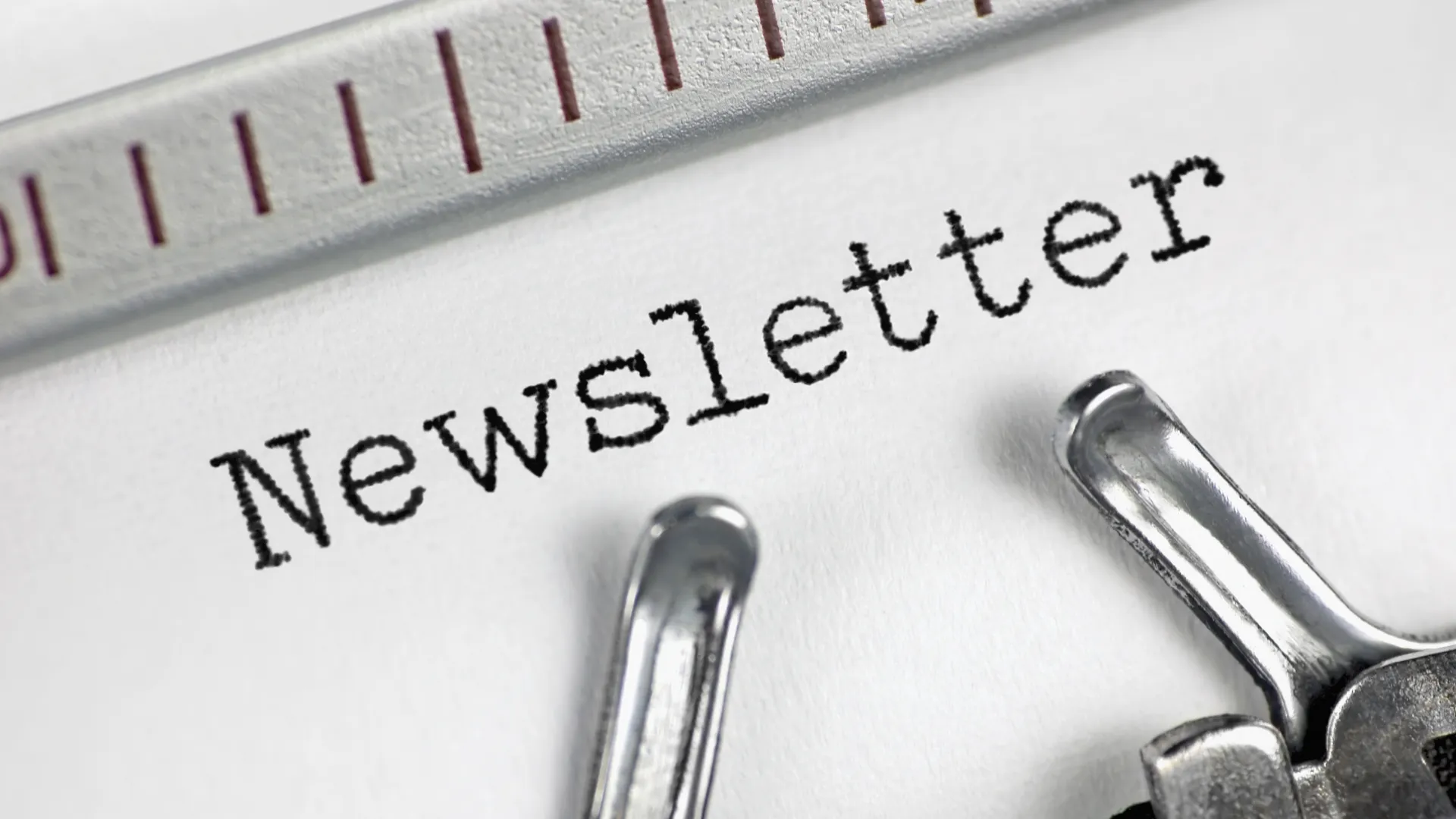 A typewriter with a sheet and the words Newsletter typed on paper