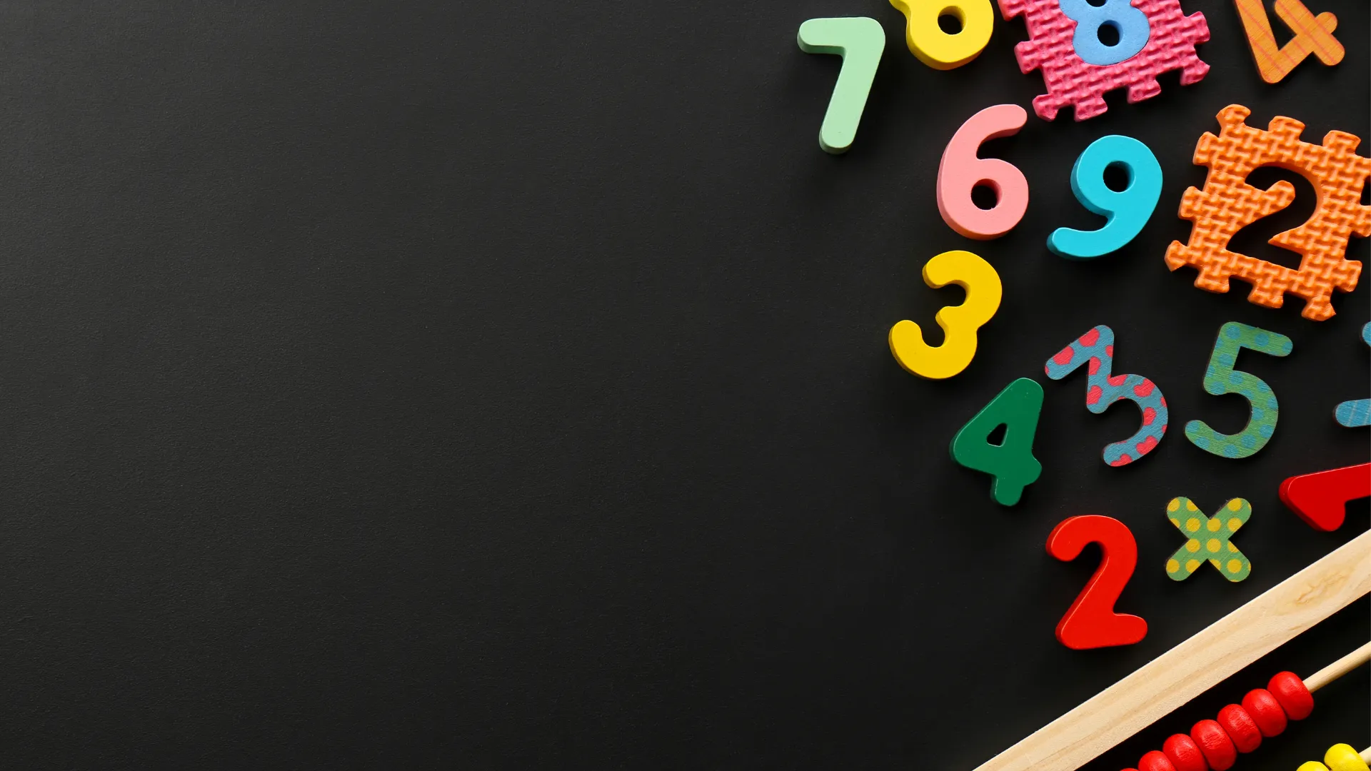 Colourful numbers and math symbols on a black background