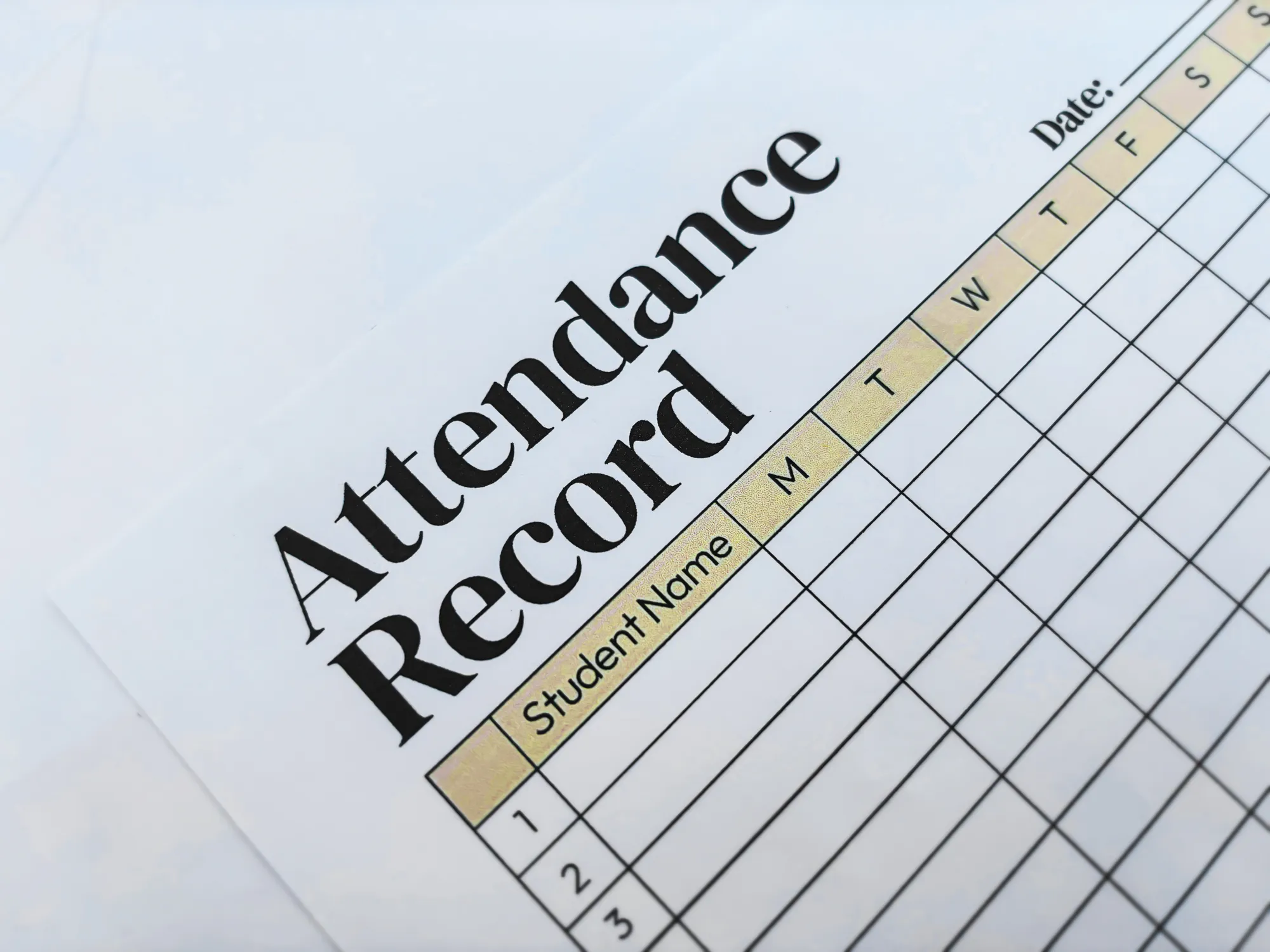 A close‑up of a printed attendance record sheet showing columns for days of the week and rows for student names.