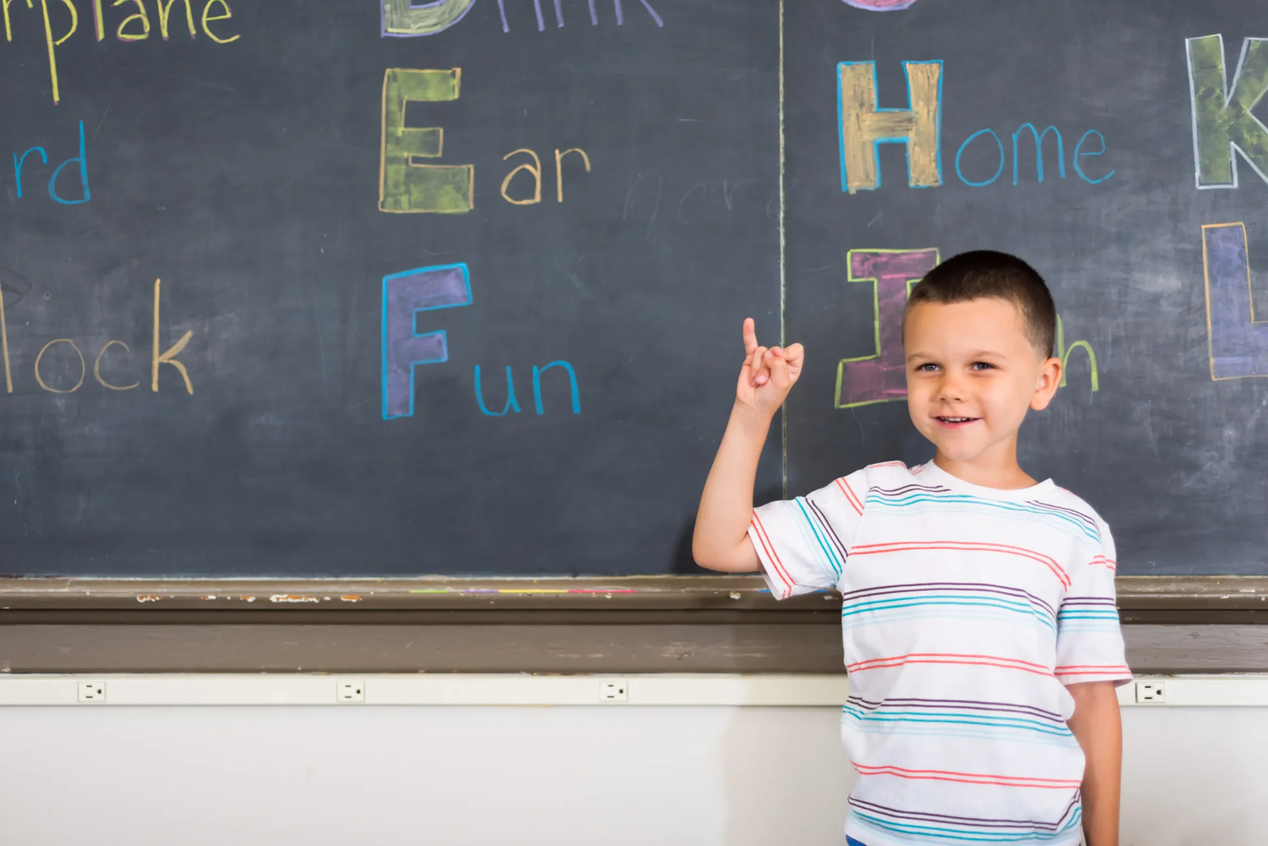 Child using sign language to communicate in class