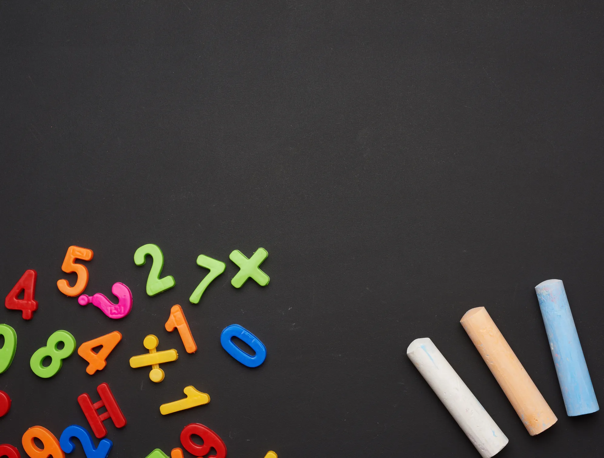 Colorful numbers and math symbols scattered on a blackboard