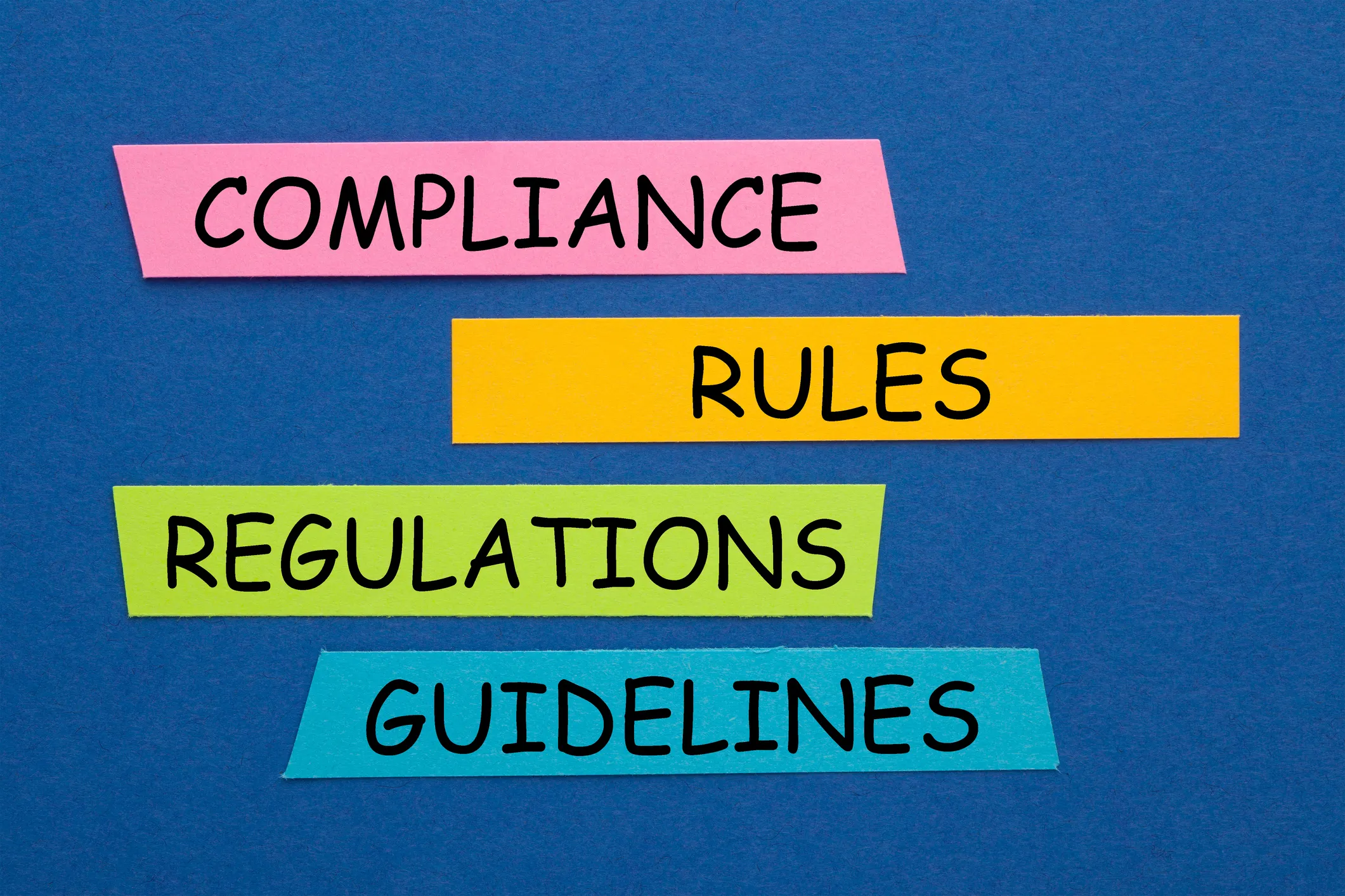 Colorful strips with the words compliance, rules, regulations, and guidelines