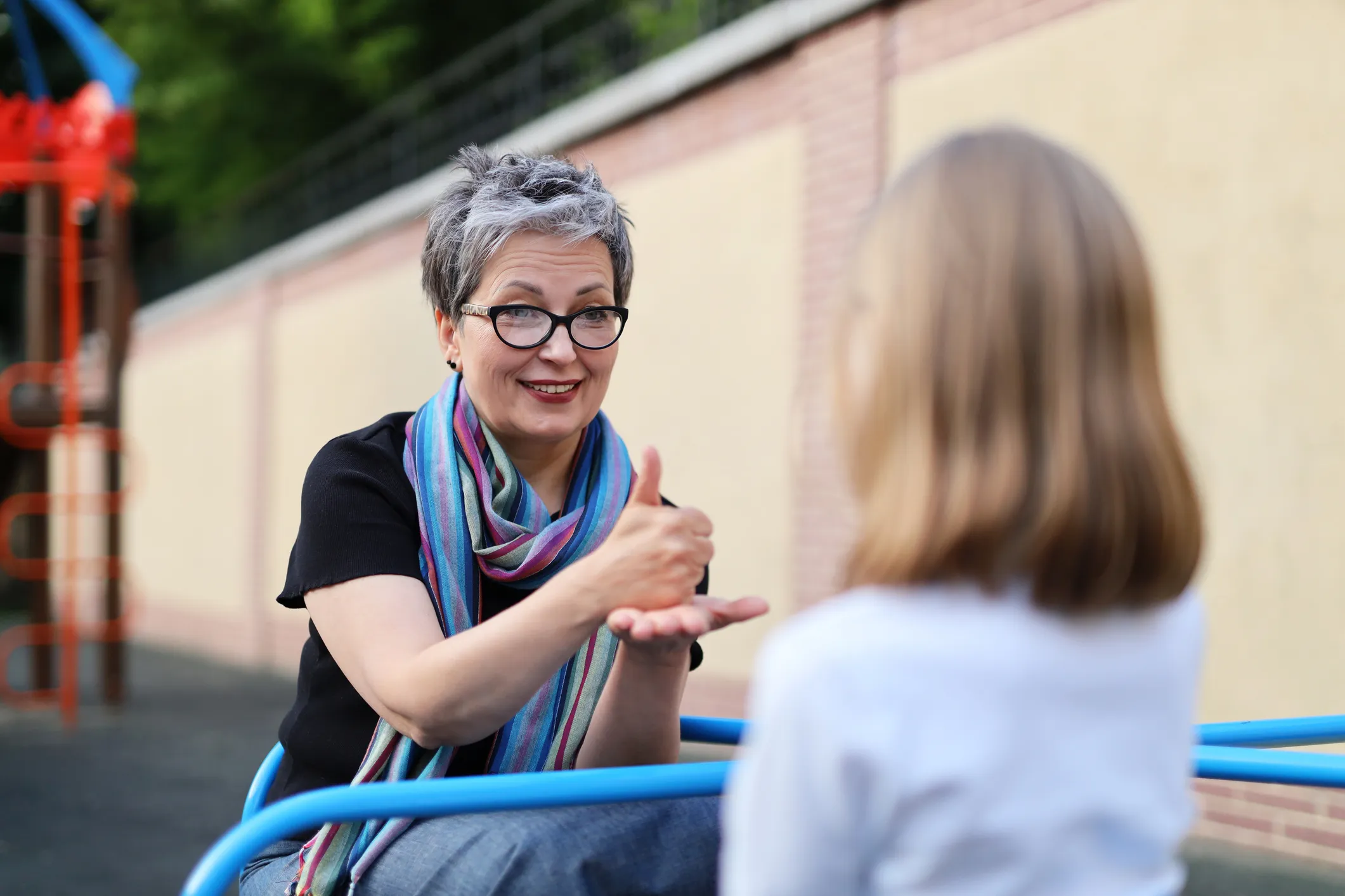 Adult using sign language to communicate with a child
